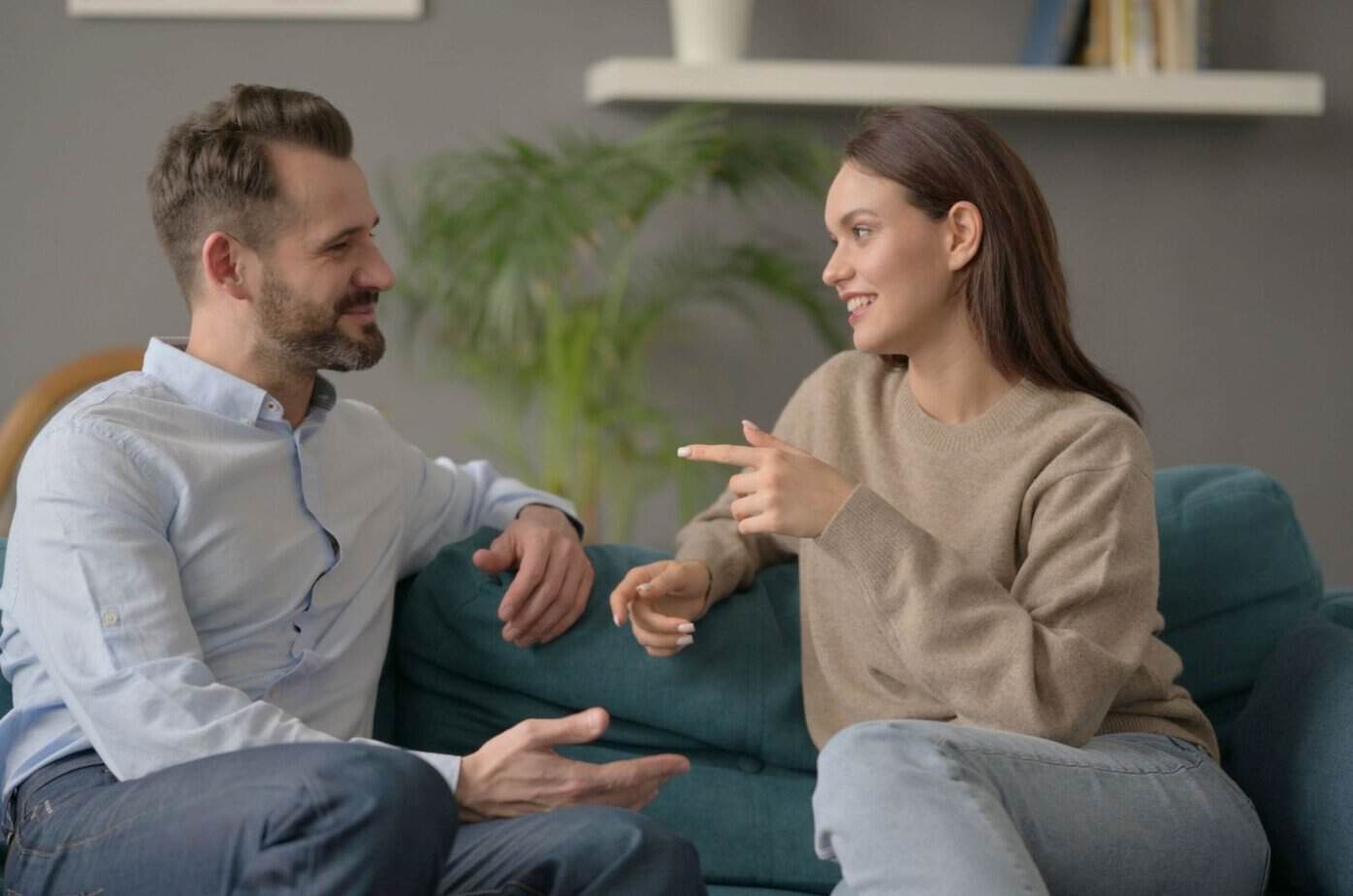 Mellom nærhet og tilbaketrekning: 5 tegn på at han kjemper mot kjærligheten til deg Mann und Frau unterhalten sich auf der Couch