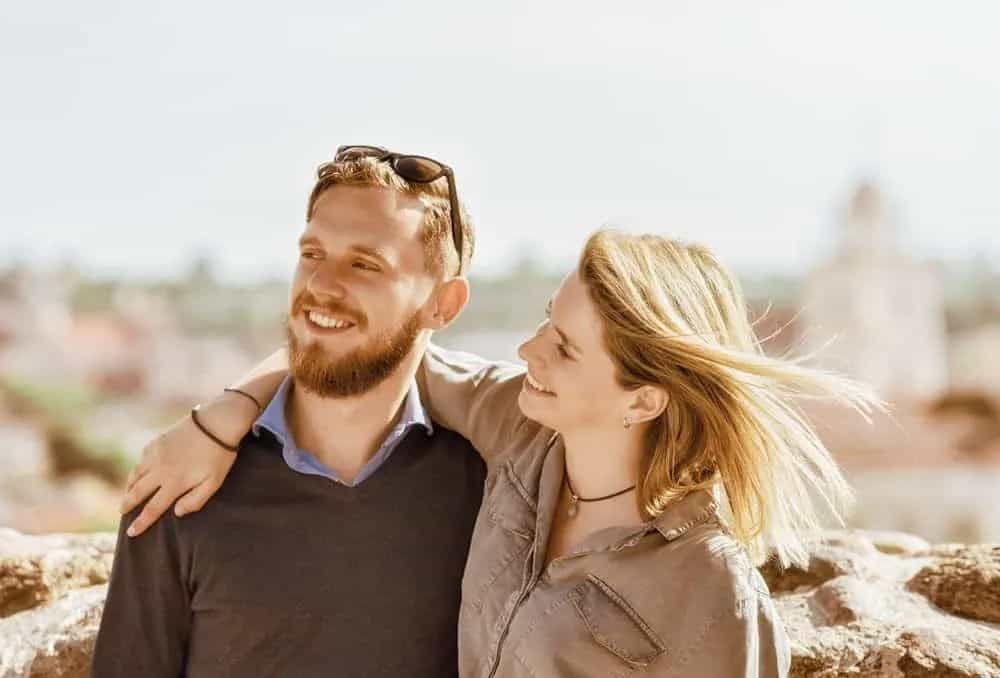 ein lächelndes Liebespaar, das in einer Umarmung steht