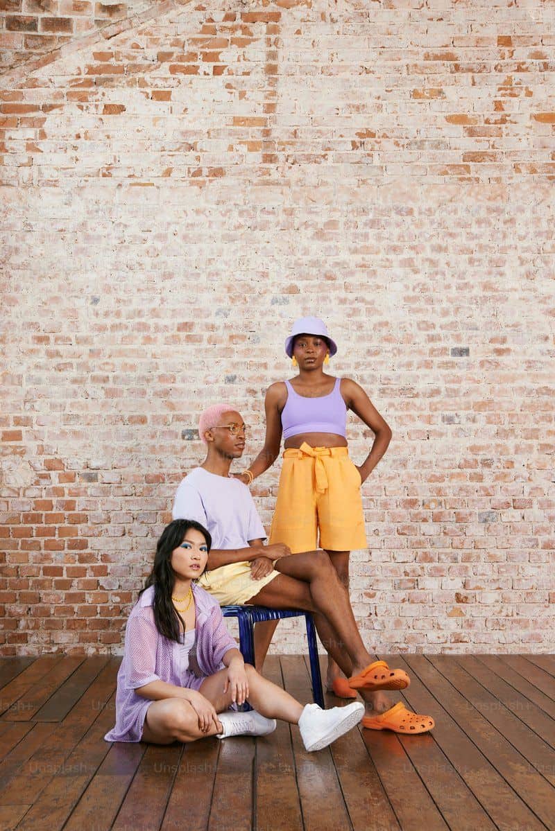 A woman sitting on a chair next to two men photo – Fashion photography Image on Unsplash A woman sitting on a chair next to two men photo – Fashion photography Image on Unsplash