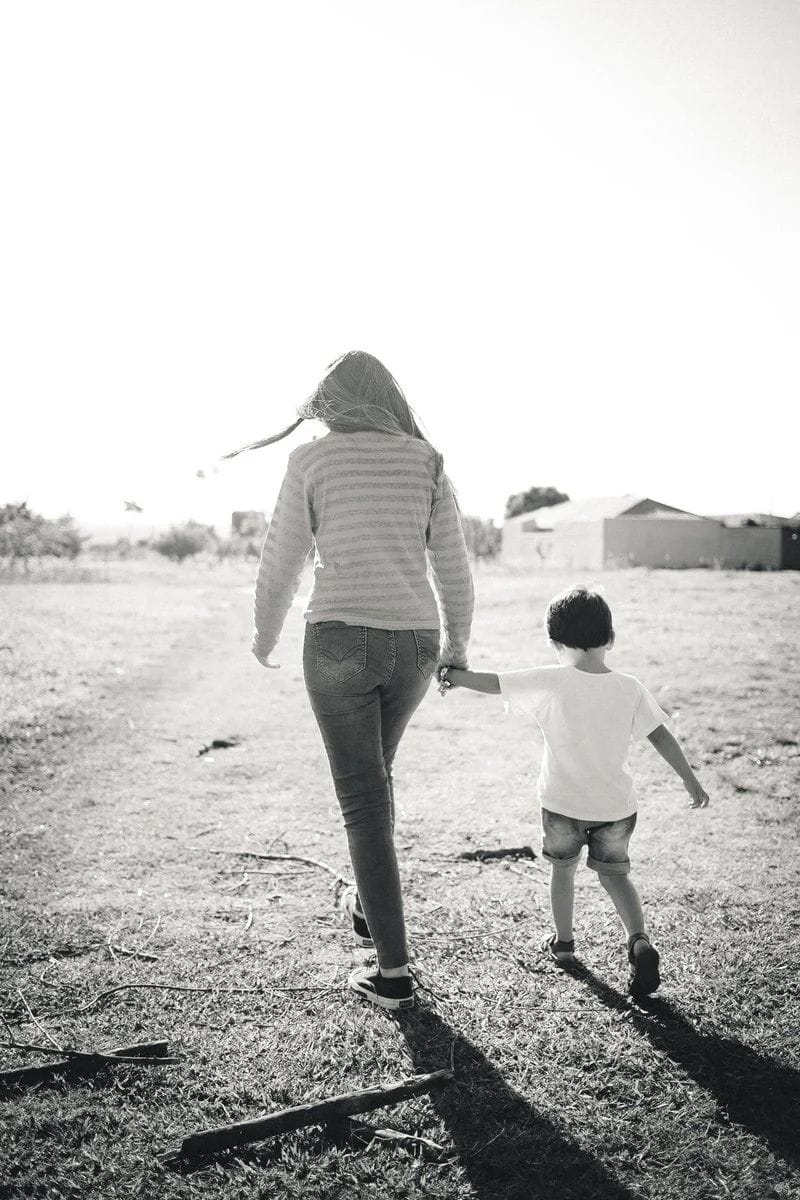 Grayscale Photo of Mother and Son Standing on Boardwalk · Free Stock Photo Grayscale Photo of Mother and Son Standing on Boardwalk · Free Stock Photo