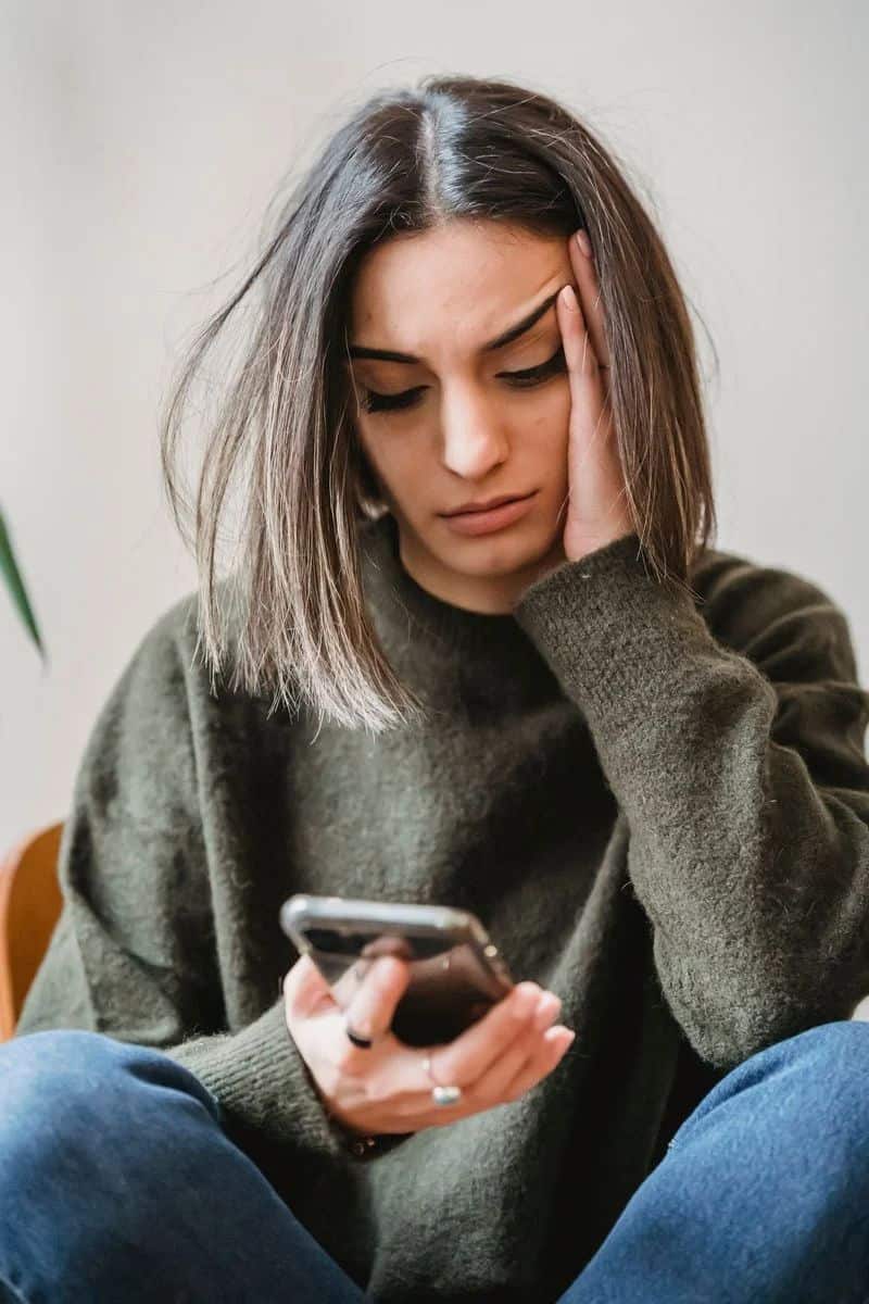 A Woman Crying While Looking at Her Phone · Free Stock Photo A Woman Crying While Looking at Her Phone · Free Stock Photo