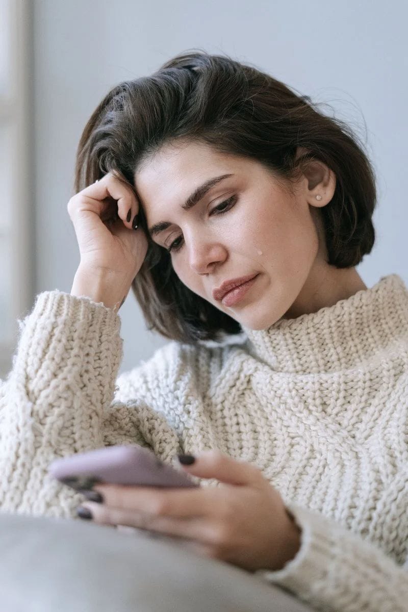 A Woman Crying While Looking at Her Phone · Free Stock Photo A Woman Crying While Looking at Her Phone · Free Stock Photo