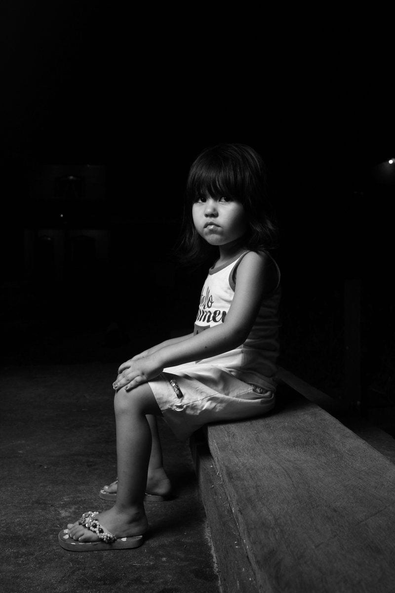 Black and White Photo of a Little Girl Sitting on a Bench in ... Black and White Photo of a Little Girl Sitting on a Bench in ...
