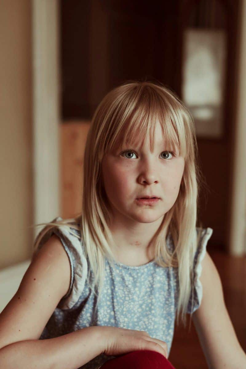 A little girl sitting on the floor with a stuffed animal ... A little girl sitting on the floor with a stuffed animal ...