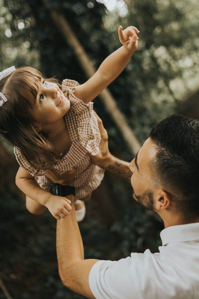Father Lifting Daughter Outdoors in Playful Moment · Free ...
