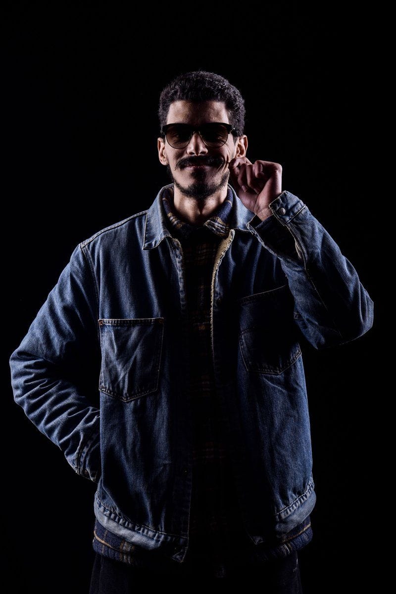 Cool Stylish Man in Denim Jacket on Dark Background · Free Stock Photo