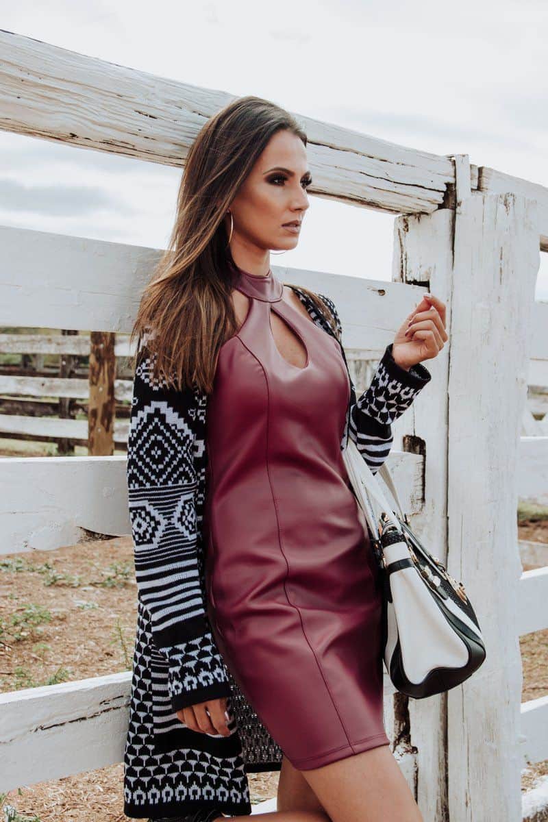Woman Wearing Maroon Leather Dress and Cardigan Leaning on White Plank Wall · Free Stock Photo Woman Wearing Maroon Leather Dress and Cardigan Leaning on White Plank Wall · Free Stock Photo
