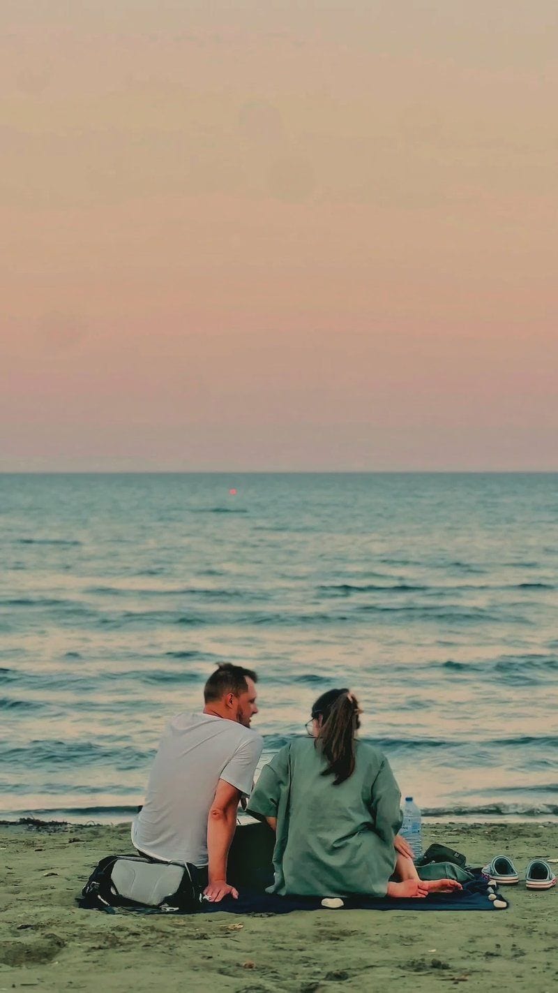 Romantic Couple on Tranquil Beach at Sunset Romantic Couple on Tranquil Beach at Sunset