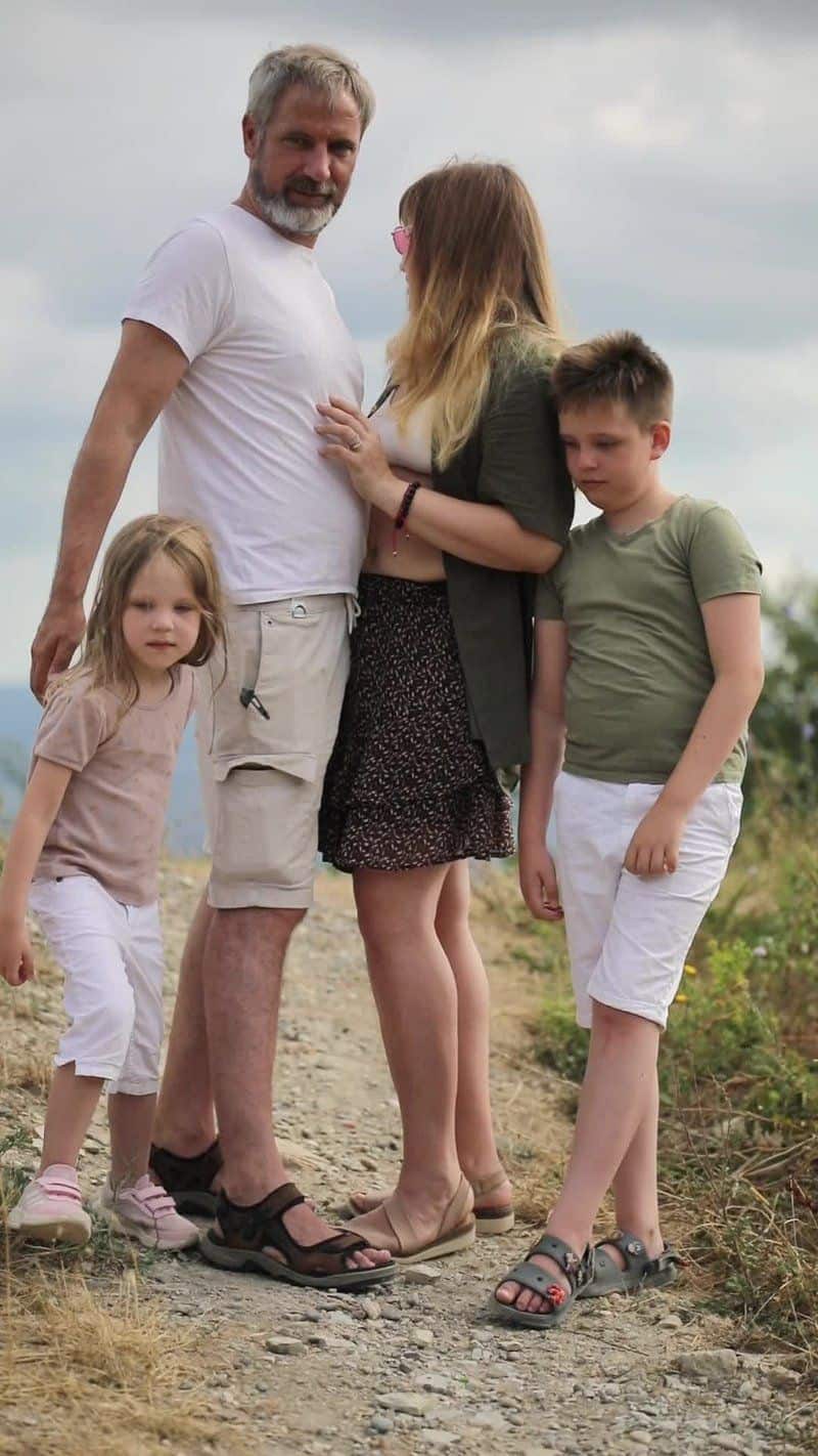 A family is standing on a dirt road A family is standing on a dirt road