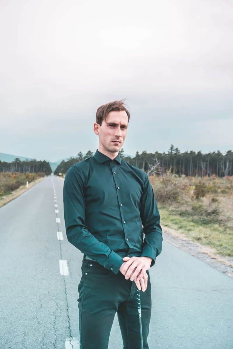 A Serious Man in Black Long Sleeves Looking at Camera while Standing on the Road · Free Stock Photo A Serious Man in Black Long Sleeves Looking at Camera while Standing on the Road · Free Stock Photo