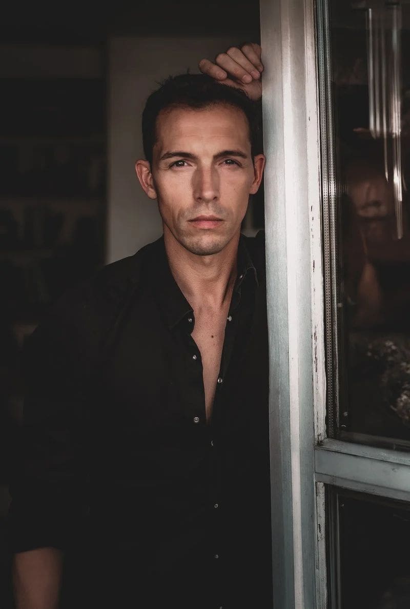 Man with a Serious Facial Expression Standing beside an Opened Window · Free Stock Photo Man with a Serious Facial Expression Standing beside an Opened Window · Free Stock Photo