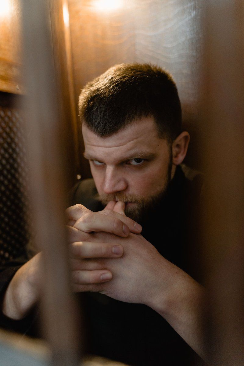 An Angry Man in Black Jacket Standing Behind Metal Bars · Free Stock Photo An Angry Man in Black Jacket Standing Behind Metal Bars · Free Stock Photo