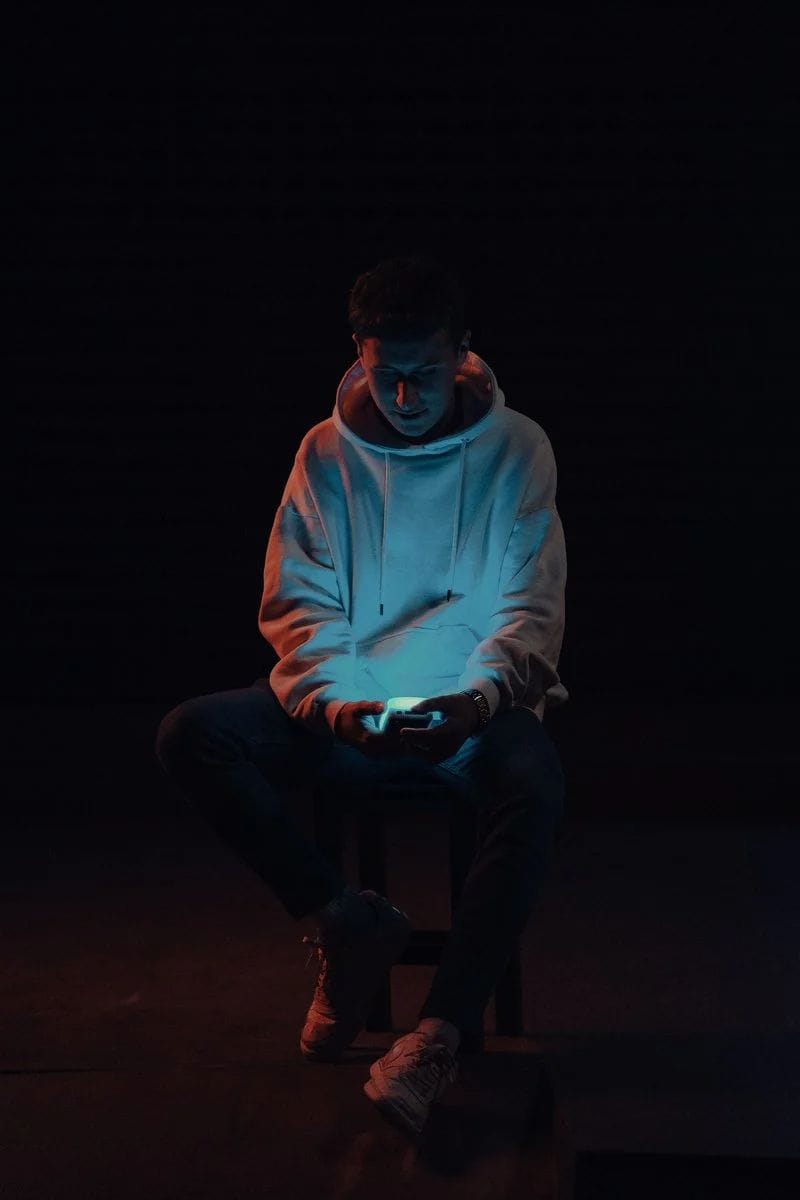 Man Sitting in Darkness Using a Smart Phone · Free Stock Photo Man Sitting in Darkness Using a Smart Phone · Free Stock Photo