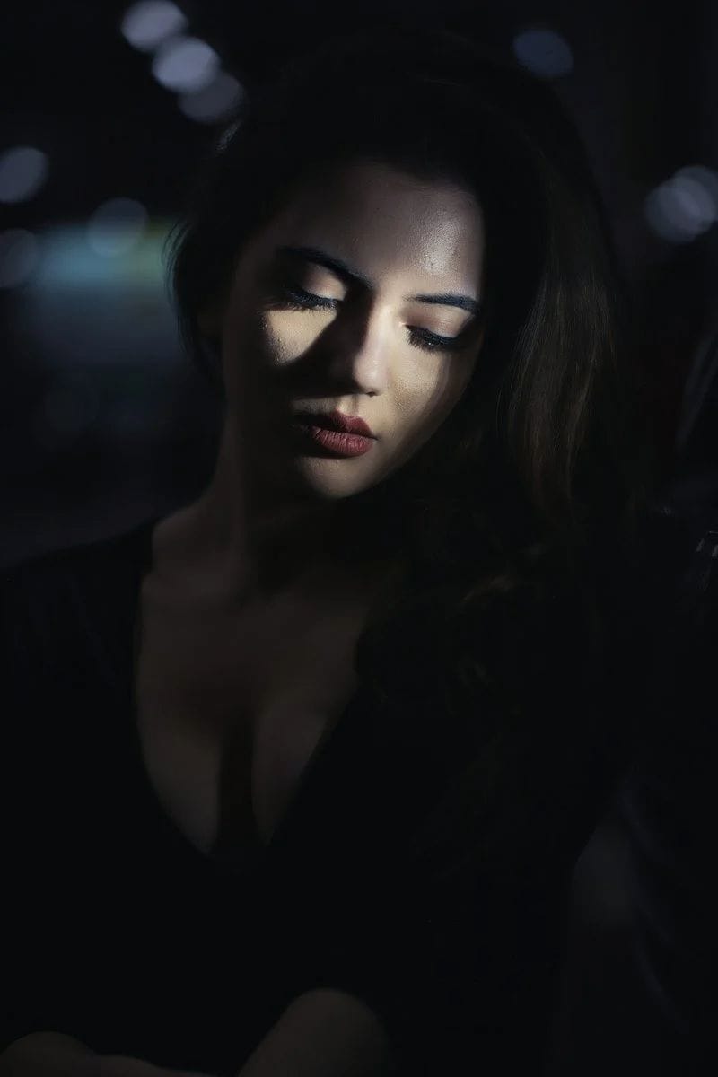 A woman in a dark room looking at her cell phone - Free Photo on Unsplash A woman in a dark room looking at her cell phone - Free Photo on Unsplash