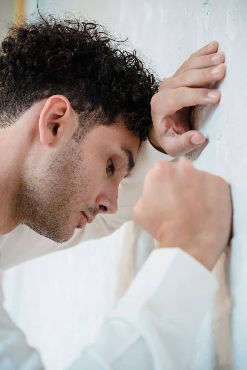 Man Leaning His Head on White Wall · Free Stock Photo Man Leaning His Head on White Wall · Free Stock Photo