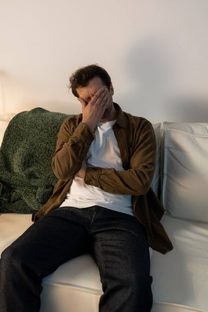 A Distressed Man Sitting on a Couch · Free Stock Photo A Distressed Man Sitting on a Couch · Free Stock Photo