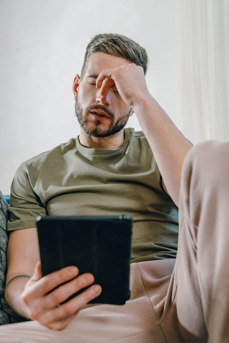 A Distressed Man Sitting on a Couch · Free Stock Photo A Distressed Man Sitting on a Couch · Free Stock Photo